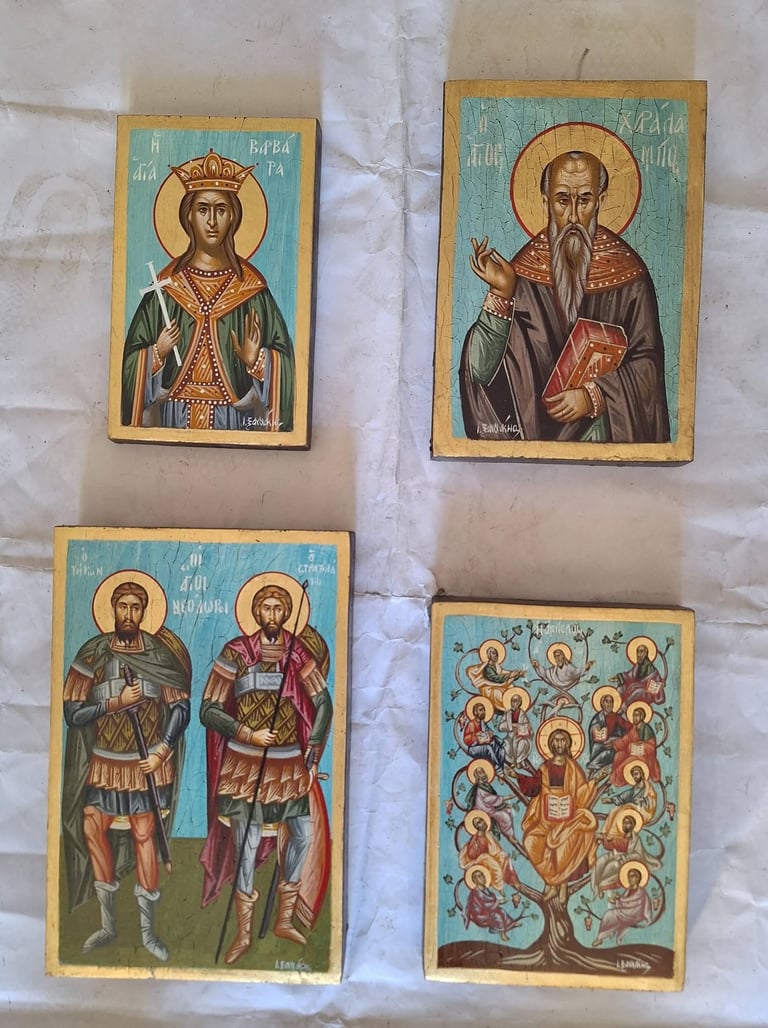Four religious icons depicting Orthodox saints with halos, gold leaf details, and Cyrillic text on wooden panels with blue backgrounds