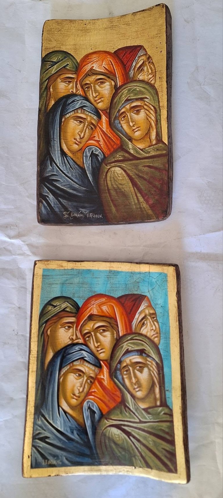 Two religious wooden icons depicting five women in traditional Orthodox Christian style, with gold and blue backgrounds and detailed facial expressions