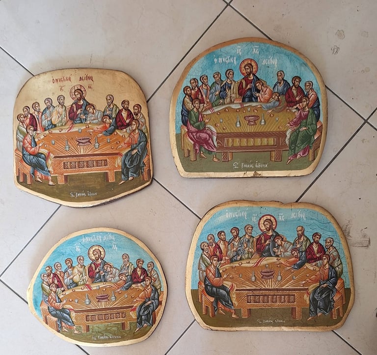 Four religious icon plaques depicting the Last Supper scene with Jesus and apostles seated at a table, arranged on a tiled surface