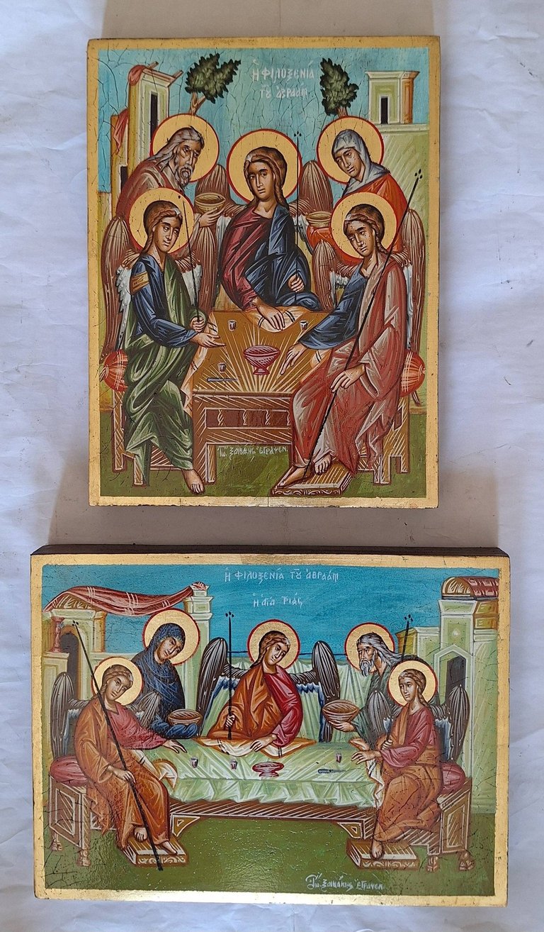 Two religious icon panels showing Orthodox Christian scenes with halos of saints around sacred figures, painted on aged wooden backgrounds