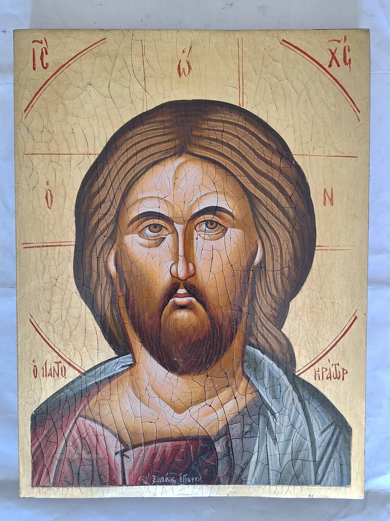 Byzantine religious icon depicting a bearded man with long hair wearing red and blue robes on a gold background with red text