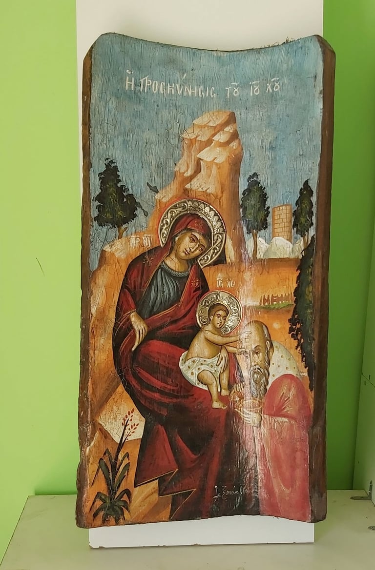 Ancient Christian icon painted on wooden panel depicting Virgin Mary holding infant Jesus with halo, dated 18th century