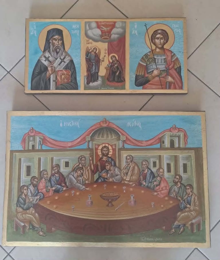 Two Orthodox Christian religious icons mounted on a tiled wall. Top panel shows three saints, bottom shows the Last Supper scene.