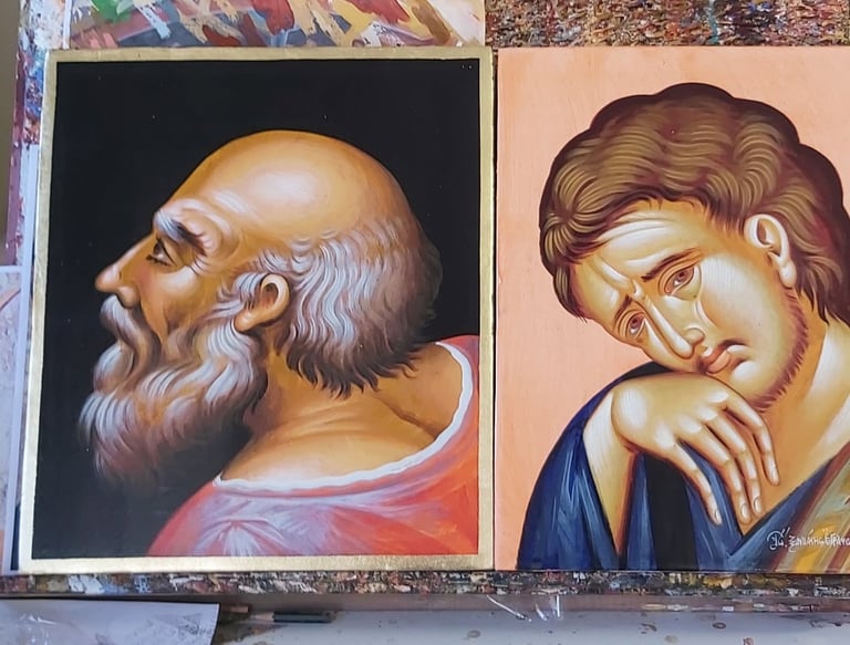 Two religious icon paintings side by side: an elderly bearded man in red robes on the left and a younger man in blue on the right