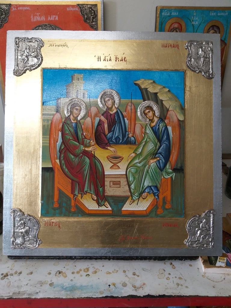 Orthodox religious icon depicting three haloed saints in robes surrounding a central altar with a chalice against blue background