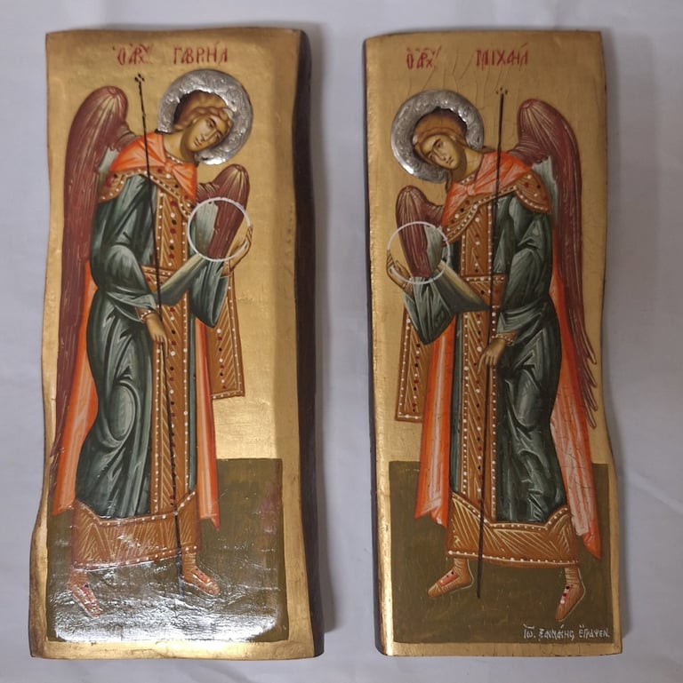 Two religious icon panels depicting the same saint figure with golden halo, burgundy wings, ornate cross, and traditional Orthodox Christian iconography