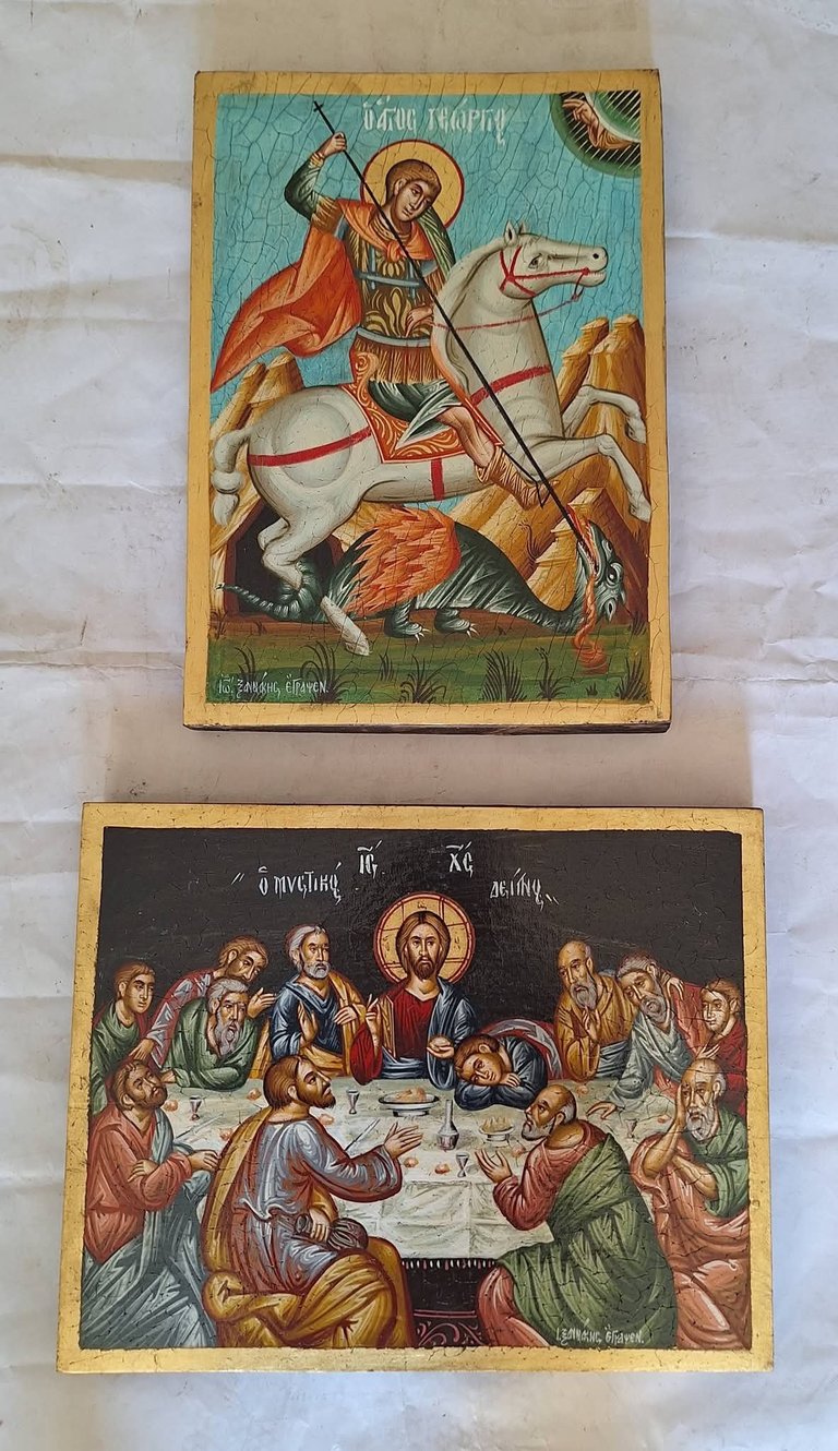 Two Orthodox Christian icon panels: top shows Saint George on white horse slaying a demon, bottom depicts the Last Supper with Christ and apostles