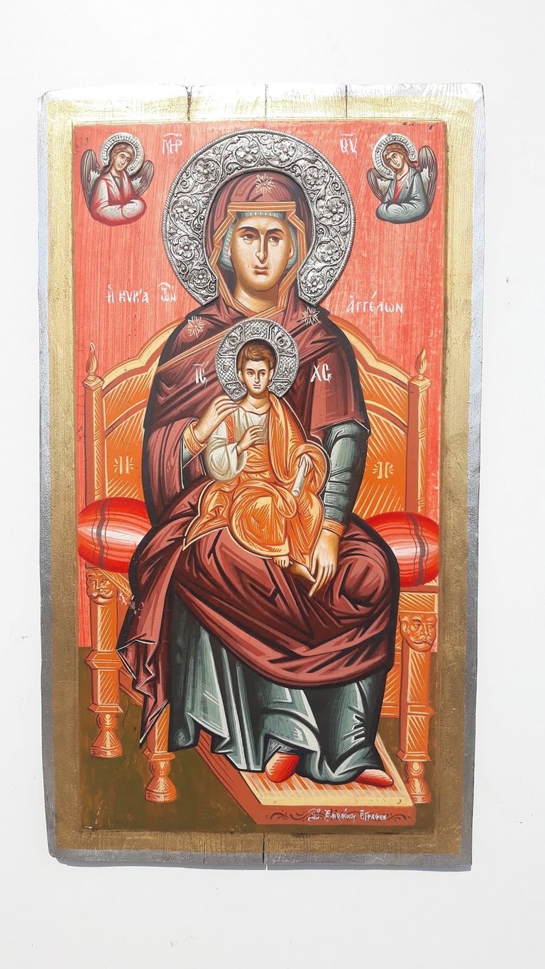Byzantine Orthodox icon depicting the Virgin Mary holding the Christ Child, with ornate halos and angels, painted in red and gold on wooden panel
