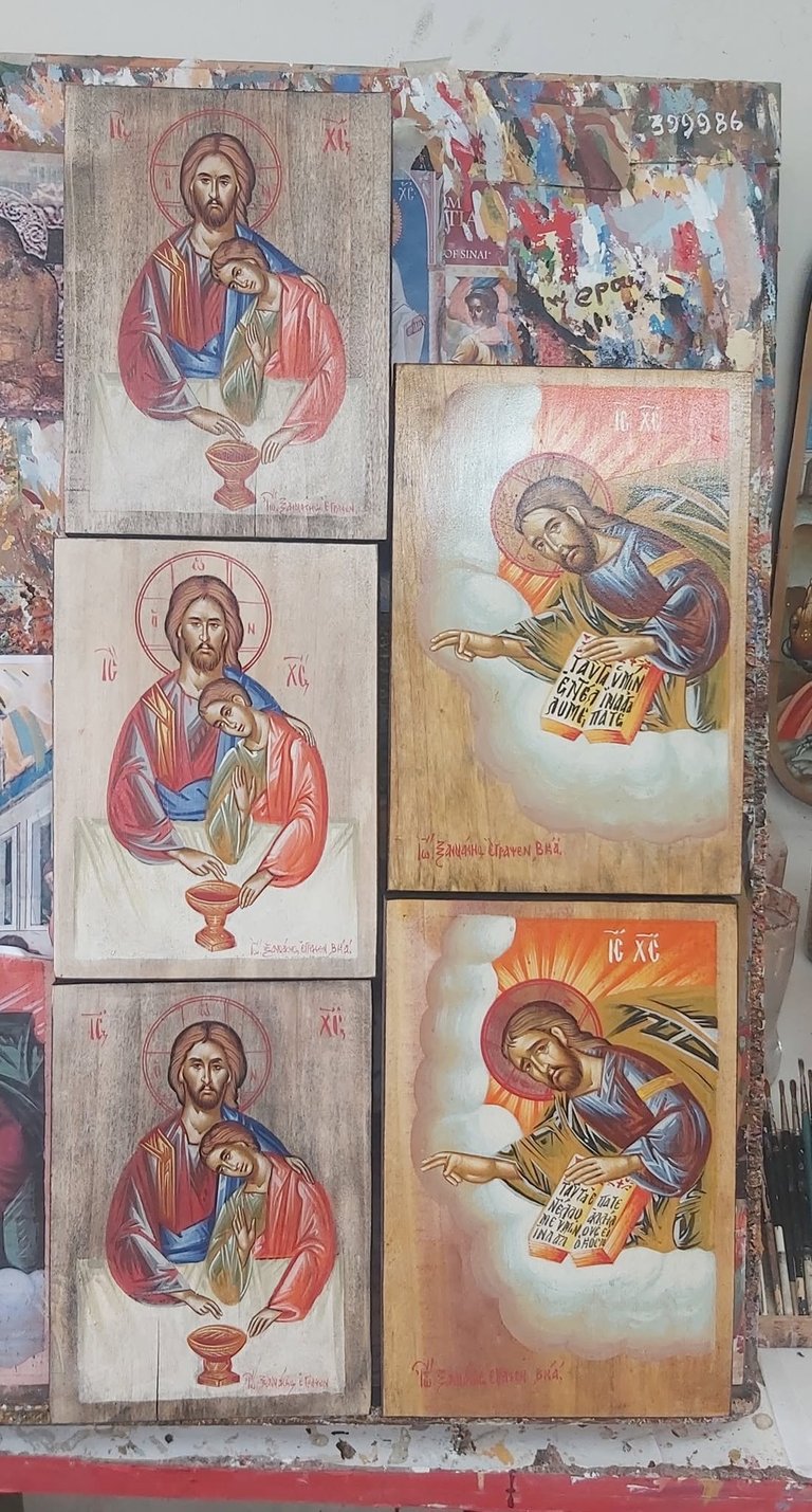 Collection of religious icon prints displaying Christ and angel figures in traditional Orthodox Christian artistic style on wooden plaques.