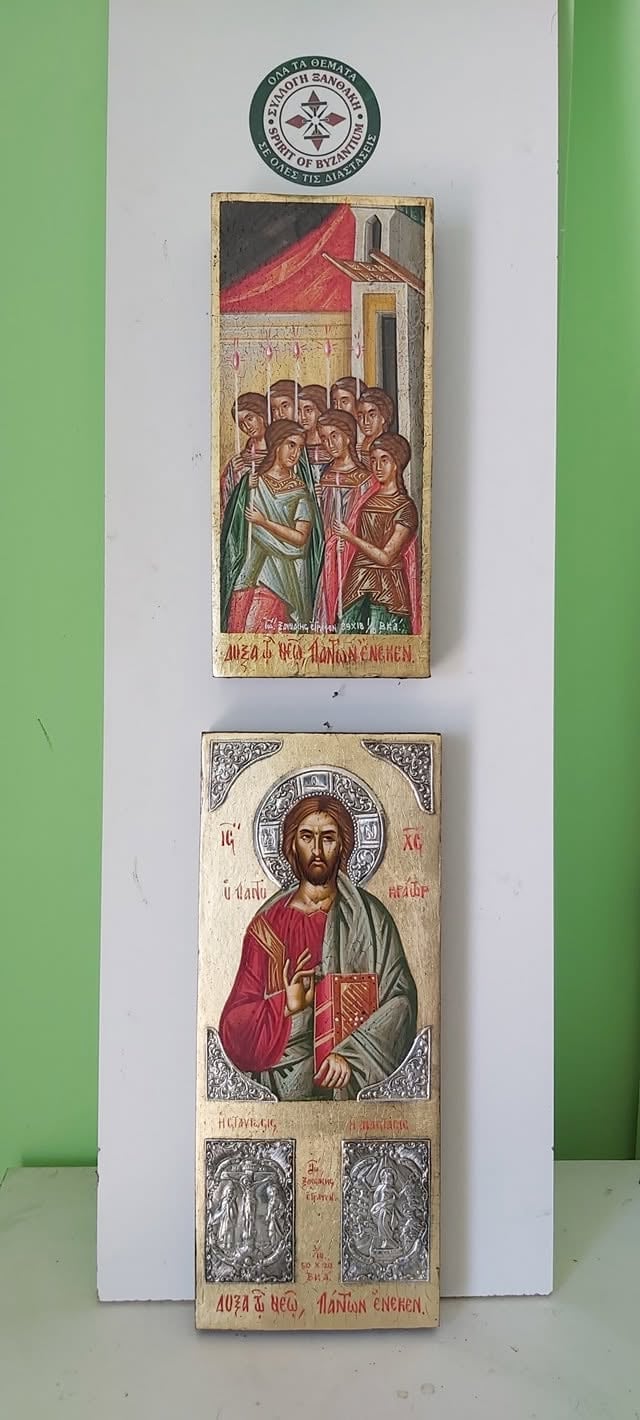 Two Orthodox religious icons mounted on white wall with green borders. Top icon shows a gathering of people under a red-roofed building. Bottom icon depicts Jesus Christ in traditional Byzantine style with halo, holding a jeweled cross.