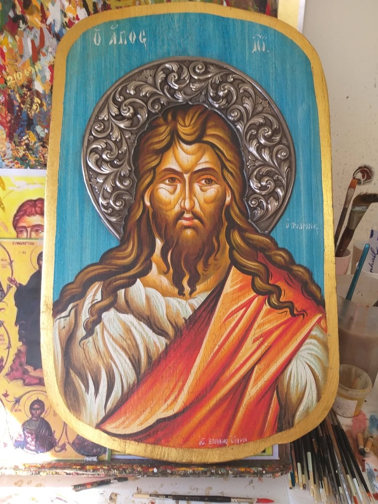 Orthodox Christian icon of Jesus Christ with long hair and beard, wearing red and white robes, with ornate silver halo on blue wooden panel