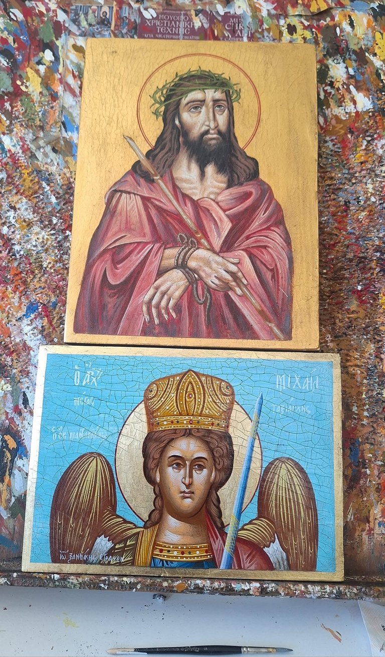 Two Orthodox religious icon paintings stacked vertically on a colorful patterned background, featuring Christ and an angel figure with traditional Byzantine artistic style