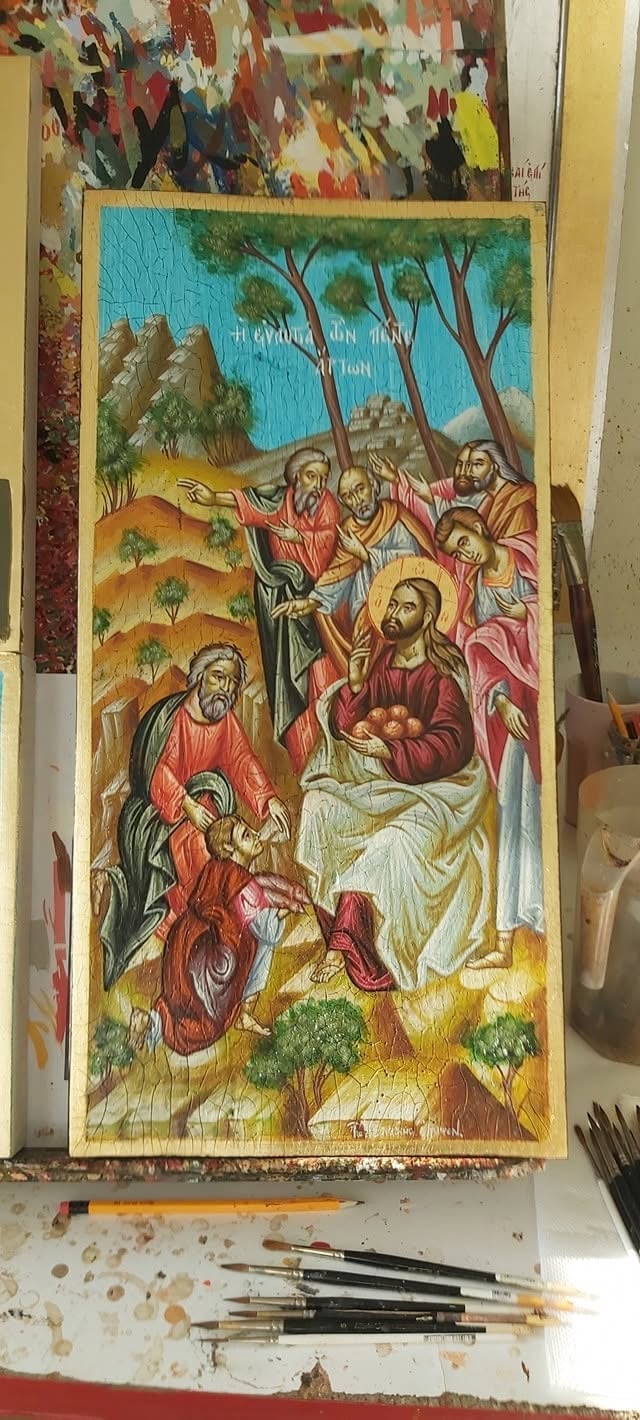 Religious artwork depicting biblical nativity scene with figures in robes under trees, painted in warm earth tones with watercolor brushes nearby