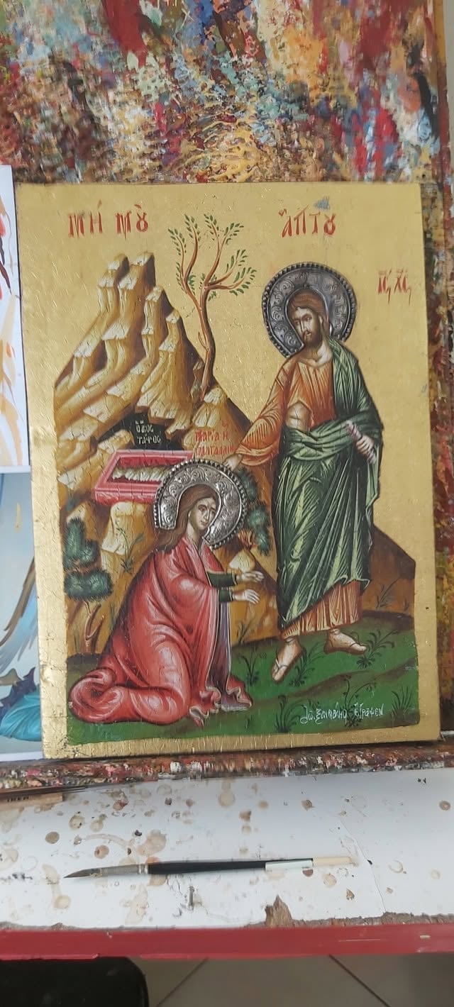 Orthodox religious icon featuring Saint appearing to kneeling figure, with mountain landscape and Greek text on gold leaf background