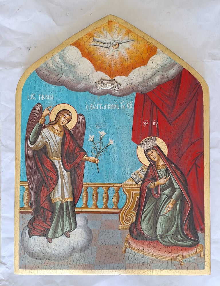 Byzantine-style religious icon showing an angel kneeling before Mary, with divine light above, painted on an arched wooden panel