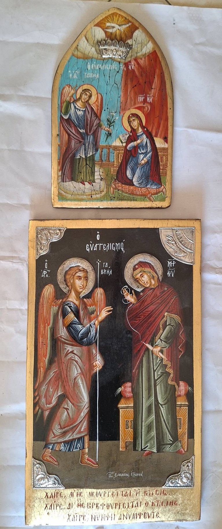 Two stacked Orthodox Christian religious icons with gold accents depicting saints with halos and Cyrillic text