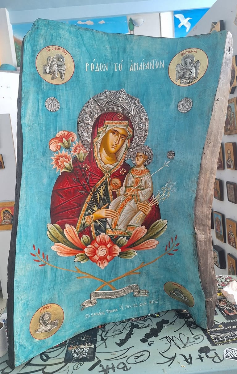 Byzantine-style religious icon on turquoise wood depicting Mary and Child with ornate circular medallions and orange flowers.