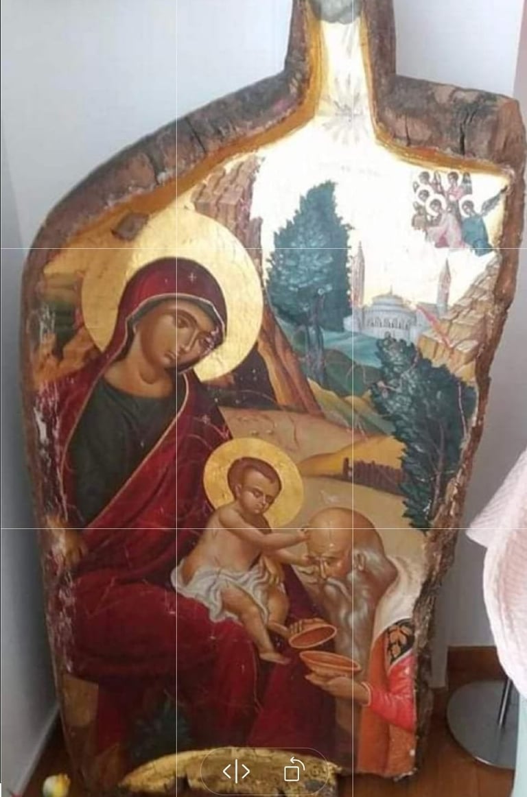 Orthodox religious icon painted on wooden panel depicting Virgin Mary with halo and child Jesus in traditional Byzantine style